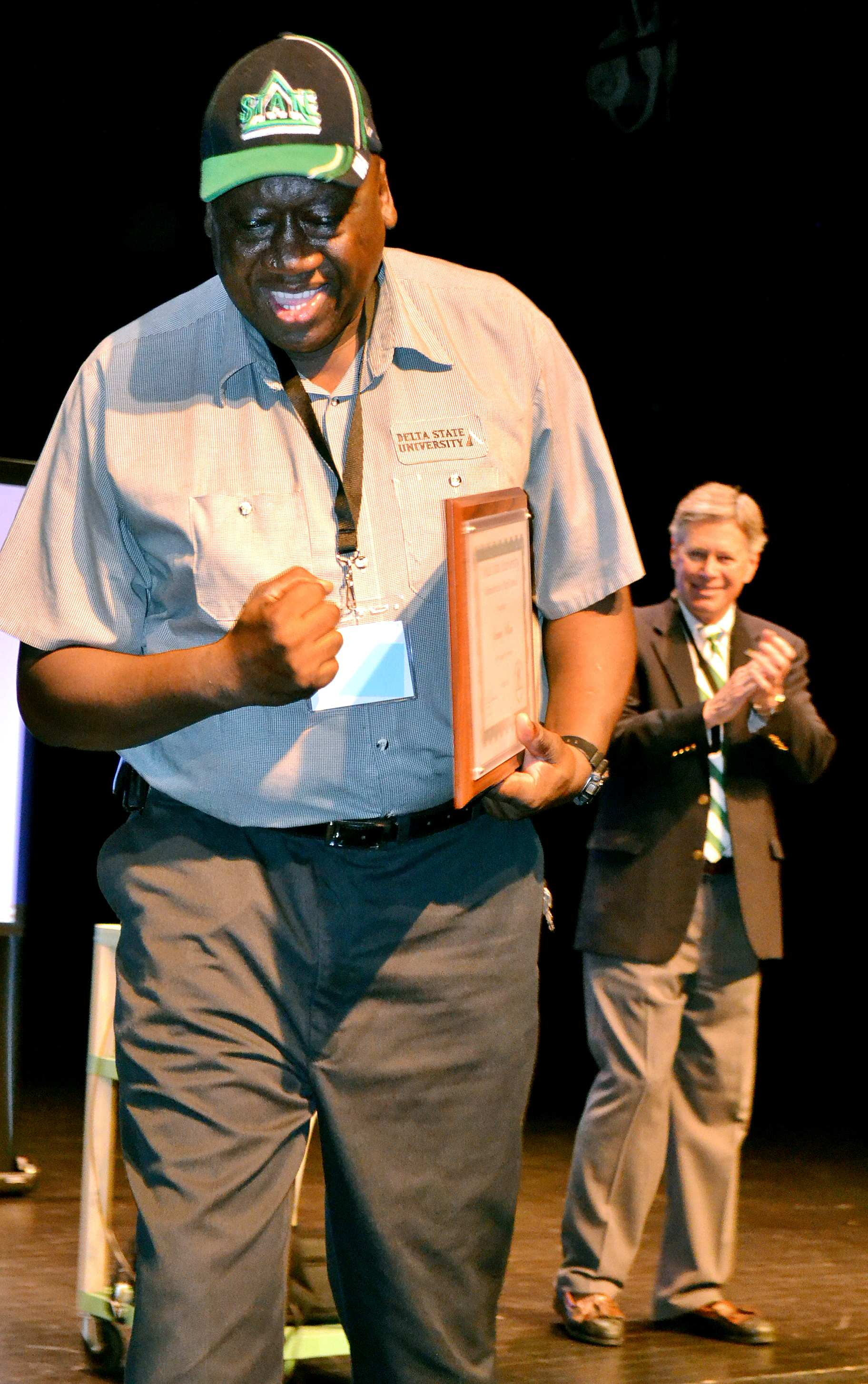 Photo: Sammy Wilson, 15-year service award recipient, celebrates after receiving his plaque from President William N. Laforge. 